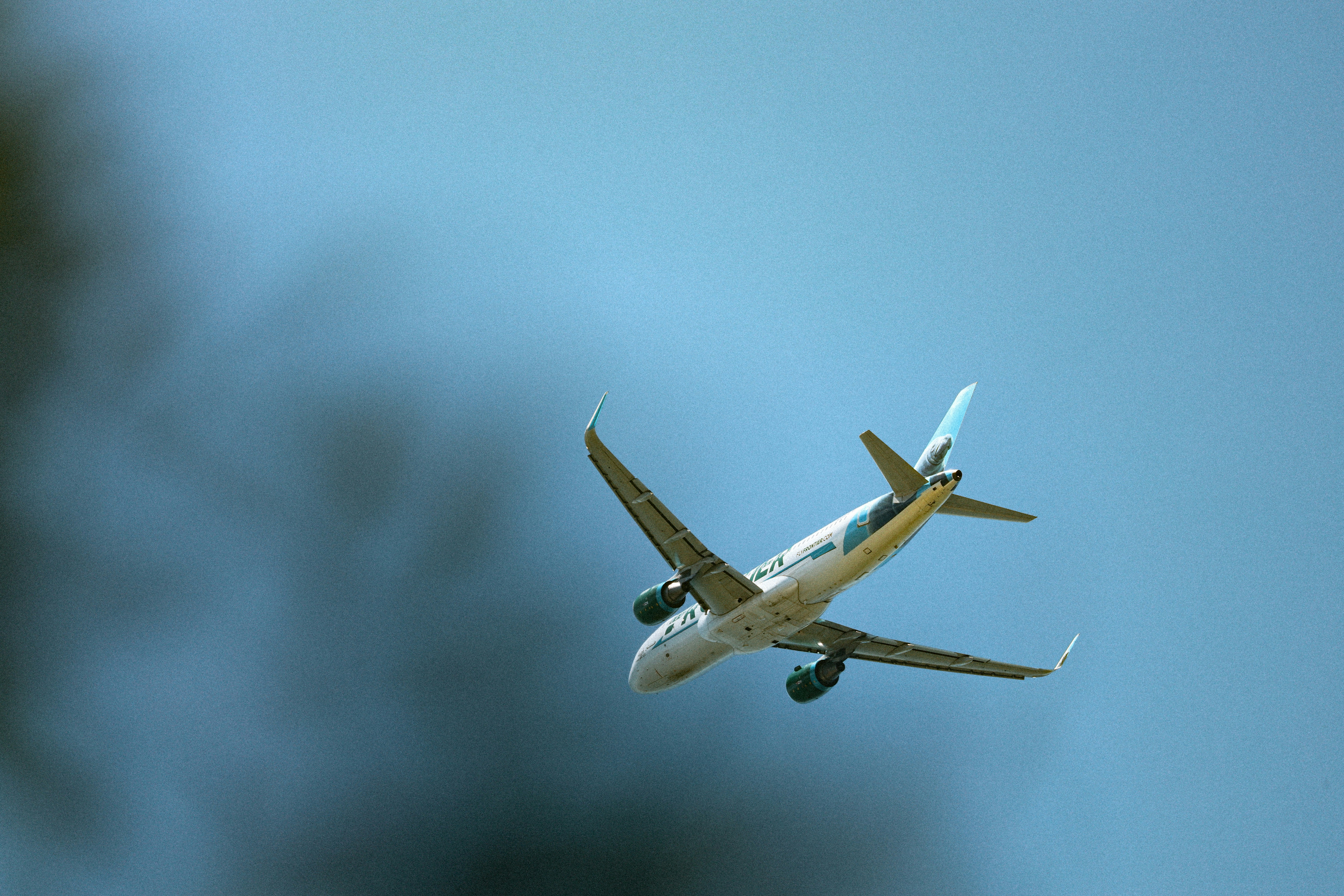 a large passenger jet flying through a blue sky